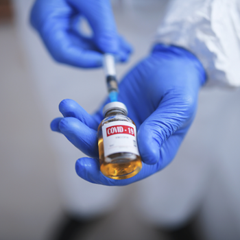 Doctor holding a vial of COVID-19 vaccine.