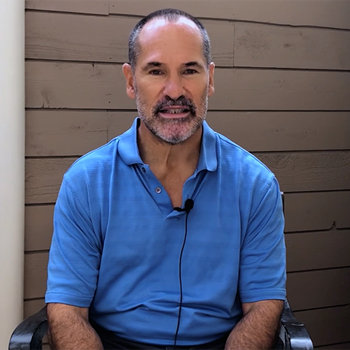 Screen grab from the video with Dr. Kaczmarek sitting in a chair. 